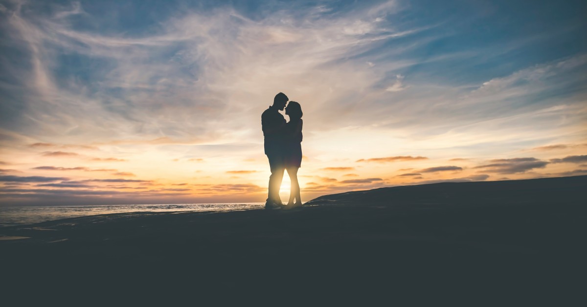 Couple in love in front of the sunset